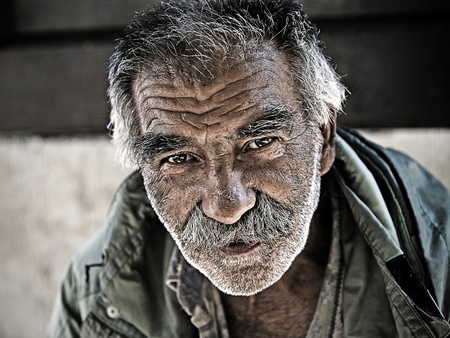 Belgrade, Serbia - August 18: An unidentified homeless man in Skadarlija - part of Belgrade, Serbia on August 18, 2011. There are many homeless and poor people on the streets of capital city in Serbia. Serbia is struggeling with poverty.のeditorial素材