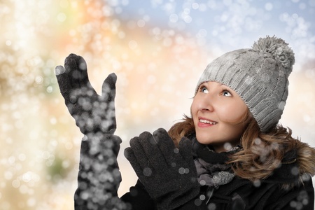 Woman in winter clothes enjoying in snowの写真素材
