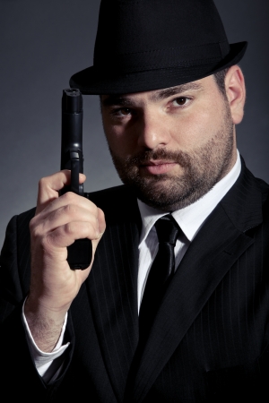 Dangerous man in suit with a gunの写真素材
