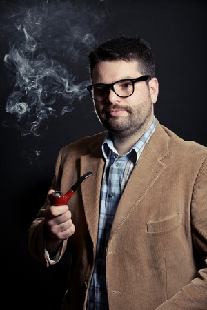 Man with pipe and glasses smokingの写真素材