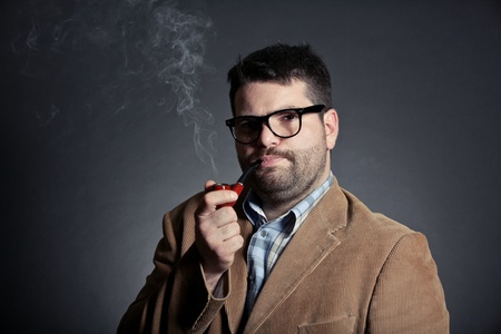 Man with pipe and glasses smokingの写真素材