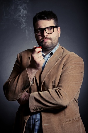 Man with pipe and glasses smokingの写真素材
