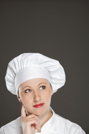 Young female chef  thinking -   bubble with copy spaceの写真素材
