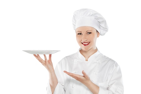 Female chef holding empty plate isolated on whiteの写真素材