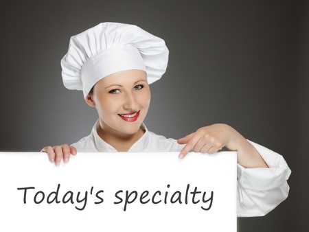 Young female chef showing today's menuの写真素材