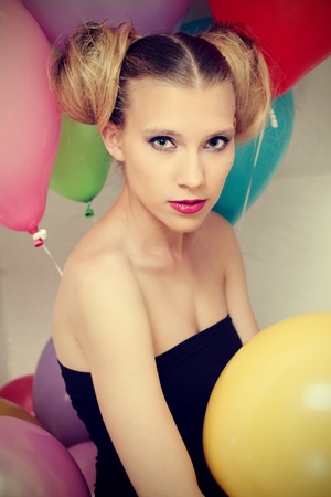 Young attractive woman posing with baloonsの写真素材