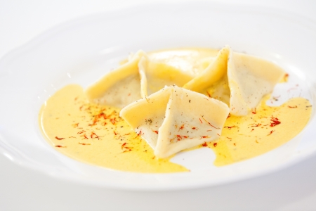 Three ravioli served on white plateの写真素材