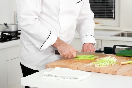 Chef cutting leek with julienne techniqueの写真素材