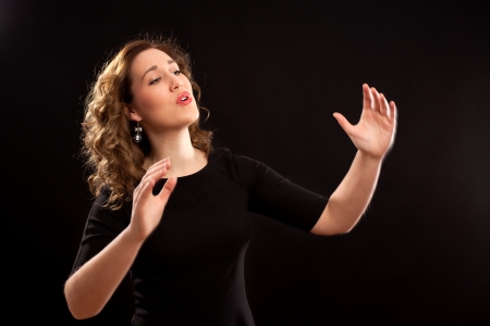 Female choir conductor during performanceの写真素材