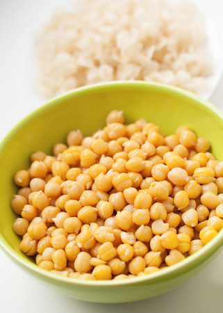 cooked and peeled chickpeas in green cupの写真素材