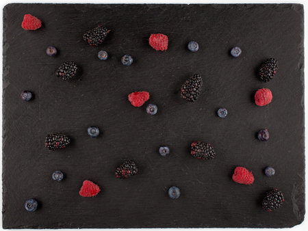 Forest berries on black stone plate