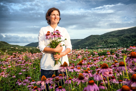 Real farmer woman in coneflower fieldの写真素材