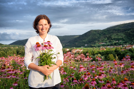Real farmer woman in coneflower fieldの写真素材
