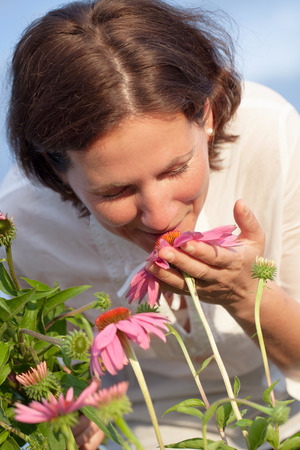 Real farmer woman in coneflower fieldの写真素材