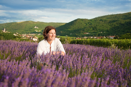 Woman in the middle of lavender fieldの写真素材