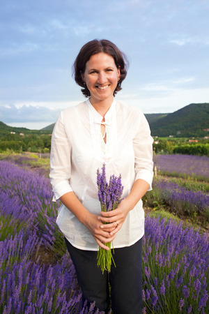 Woman holding lavander flowers bouquetの写真素材