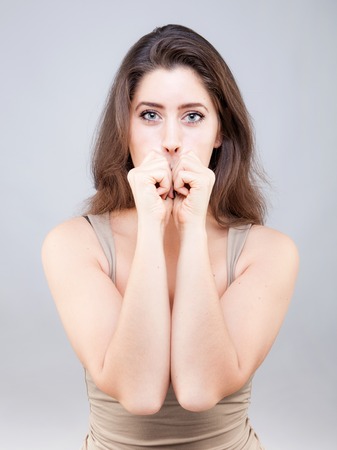 Beautiful young caucasian woman doing face yoga poseの写真素材