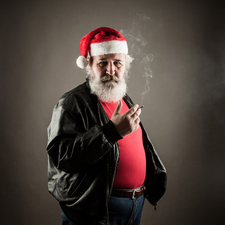 Grumpy badass Santa Claus with cigaretteの写真素材