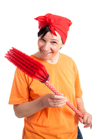 Middle aged woman smiling with dotted broom isolated on whiteの写真素材