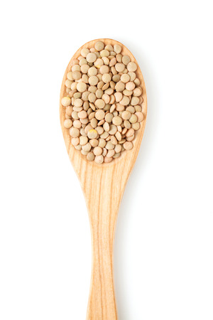 Lentils on wooden spoon isolated on white backgroundの写真素材