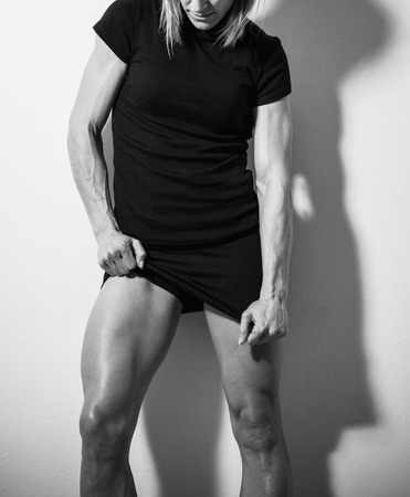 Torso of strong female body against white wallの写真素材