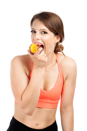 Smiling fit young and attractive woman in studioの写真素材