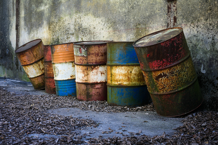 Abandoned rusty barrels with dangerous chemicals insideの写真素材