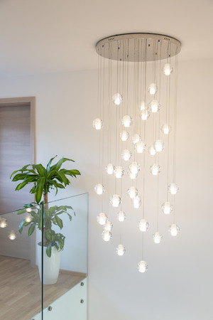 Modern chandelier above staircase in real homeの写真素材