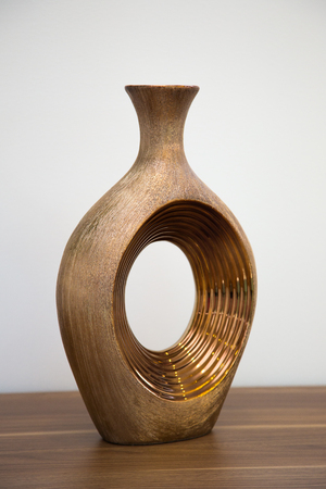 Elegant bronze vase on oak shelf5の写真素材
