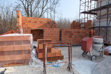 Unfinished building next to prefabricated houseの写真素材