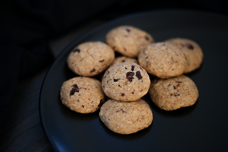 Home made chocolate chip paleo cookies on black plateの写真素材