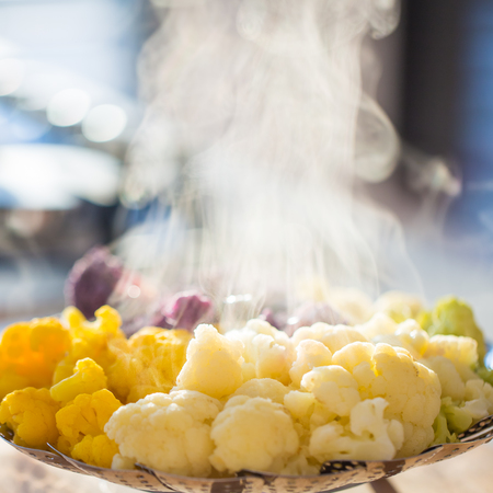 Steamed cauliflower cooling against evening lightの写真素材