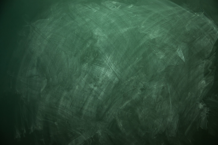 Blank green chalkboard with traces of erased chalkの写真素材