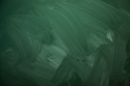 Blank green chalkboard with traces of erased chalkの写真素材