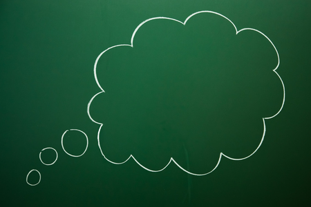 Empty think cloud box drawn on green blackboardの写真素材