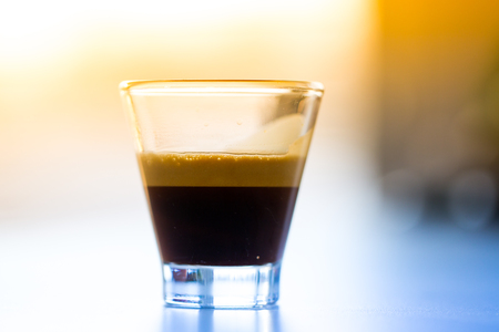 Espresso coffee in glass in the morning lightの写真素材