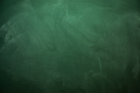 Blank green chalkboard with traces of erased chalkの写真素材