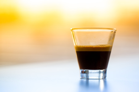Espresso coffee in glass in the morning lightの写真素材