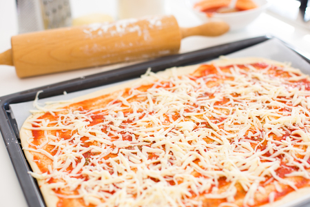 Preparing pizza at home with healthy local ingredientsの写真素材