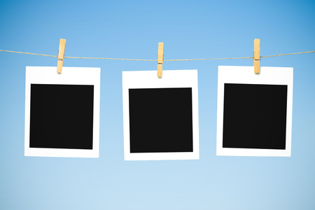 Three blank polaroid photos against blue skyの写真素材