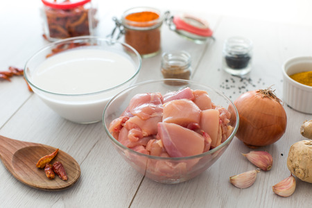 Ingredients for modern spicy chicken curry on wooden deskの写真素材