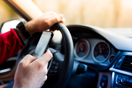 Dangerous texting and driving at the same timeの写真素材