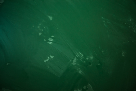 Blank green chalkboard with traces of erased chalkの写真素材