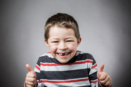 Joyful little boy with toothless smile smilingの写真素材
