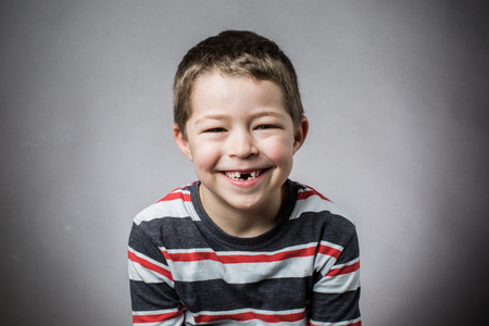 Joyful little boy with toothless smile smilingの写真素材