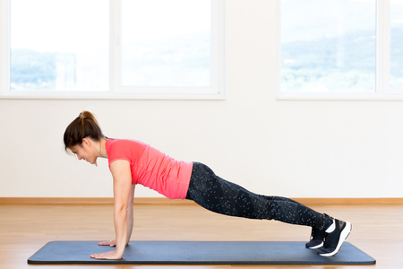 Active young woman exercising at the gymの写真素材
