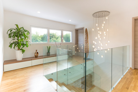 Modern glass fence on the wooden staircaseの写真素材