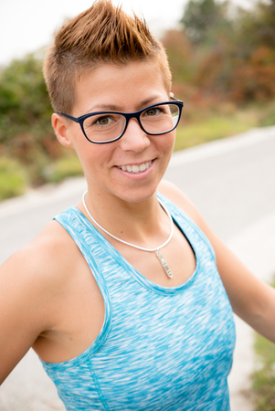 Woman with pixie after workout in autumn natureの写真素材