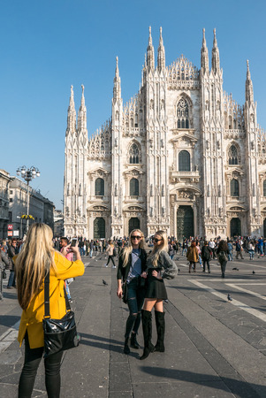 MILAN, ITALY - NOVEMBER 3, 2017: Two beautiful girls posing in front of Milan's Cathedral on November 3, 2017 in Milan, Italyのeditorial素材