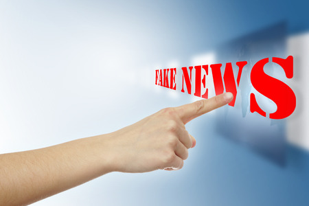 Pointer finger touching virtual fake news textの写真素材